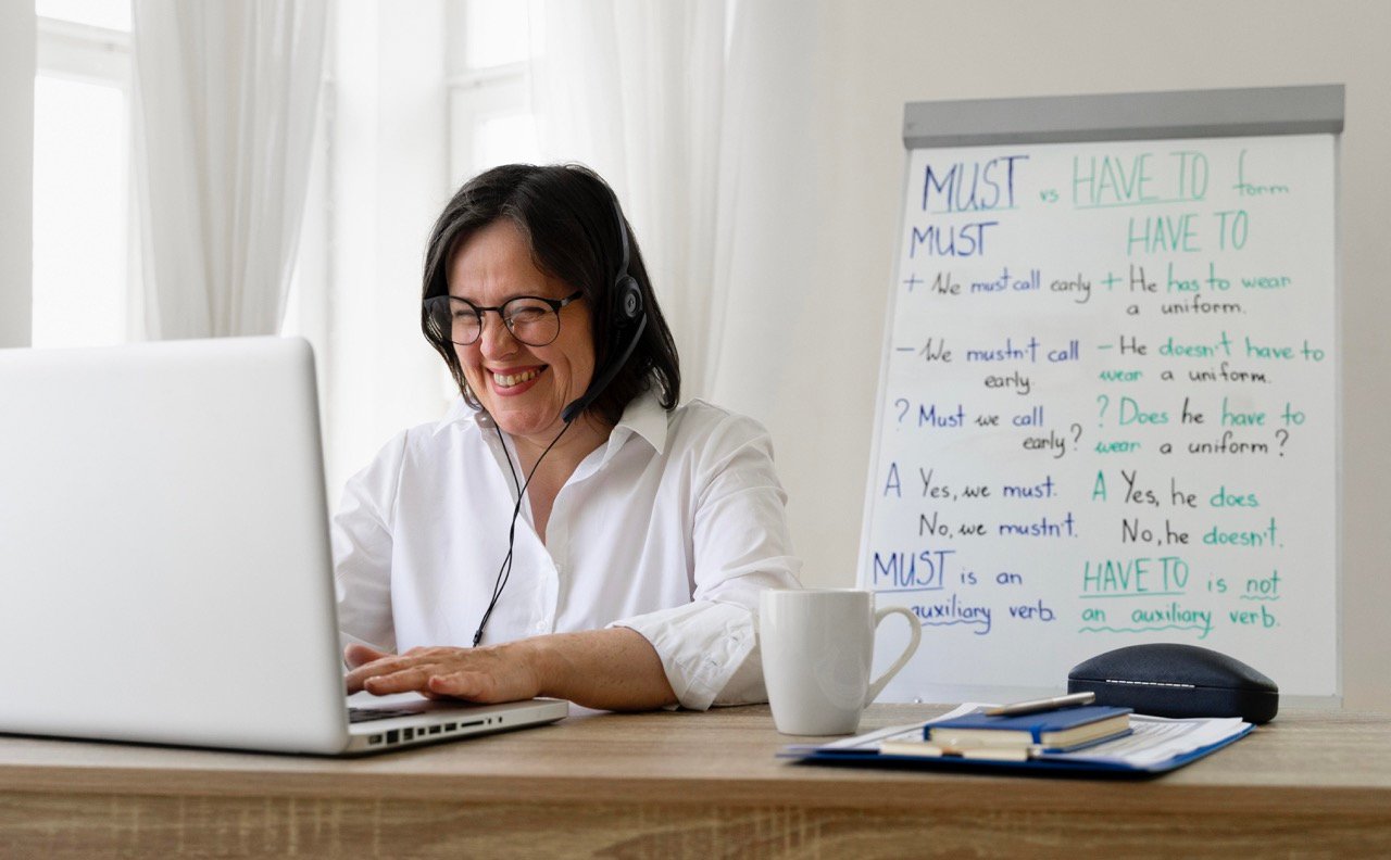 Teacher Laughing with student in online classroom