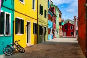 Brightly colored buildings lining a quiet street in a vibrant European neighborhood