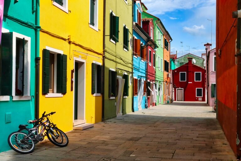 Brightly colored buildings lining a quiet street in a vibrant European neighborhood