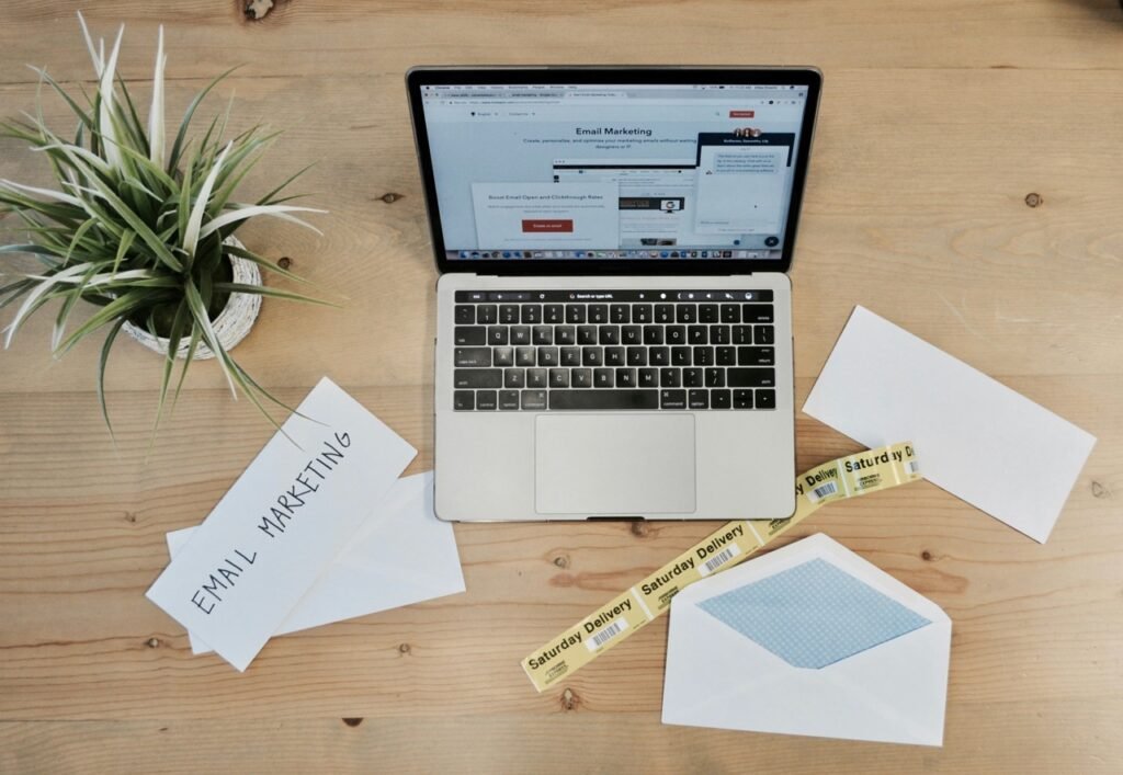 Laptop displaying an email marketing platform on a wooden desk