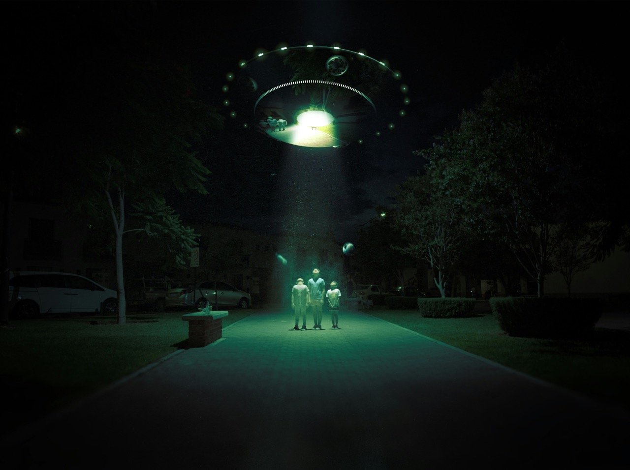 Family watching a glowing unidentified object in the night sky