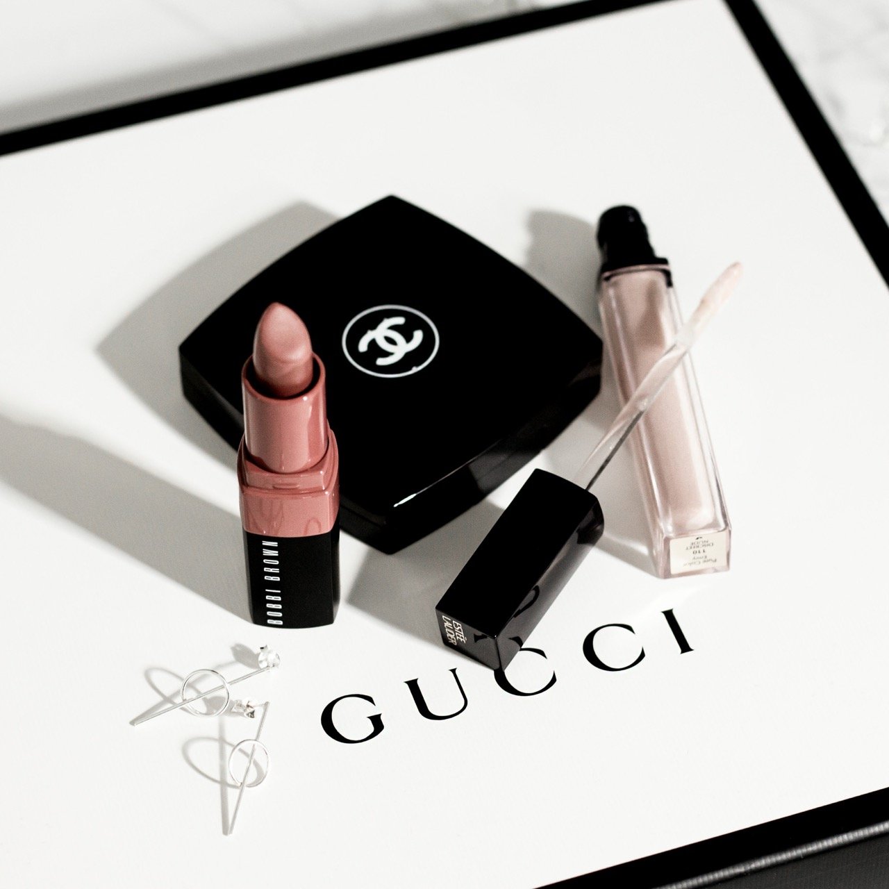 Luxury beauty products representing the appeal of expensive name-brand products and cheaper dupes