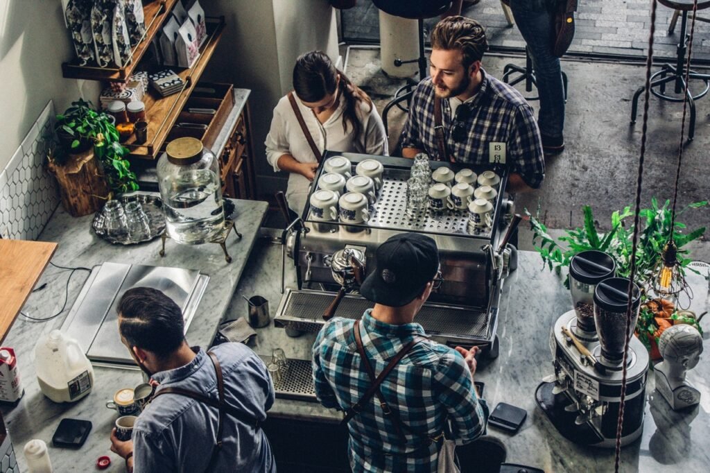 Baristas preparing coffee behind a café counter