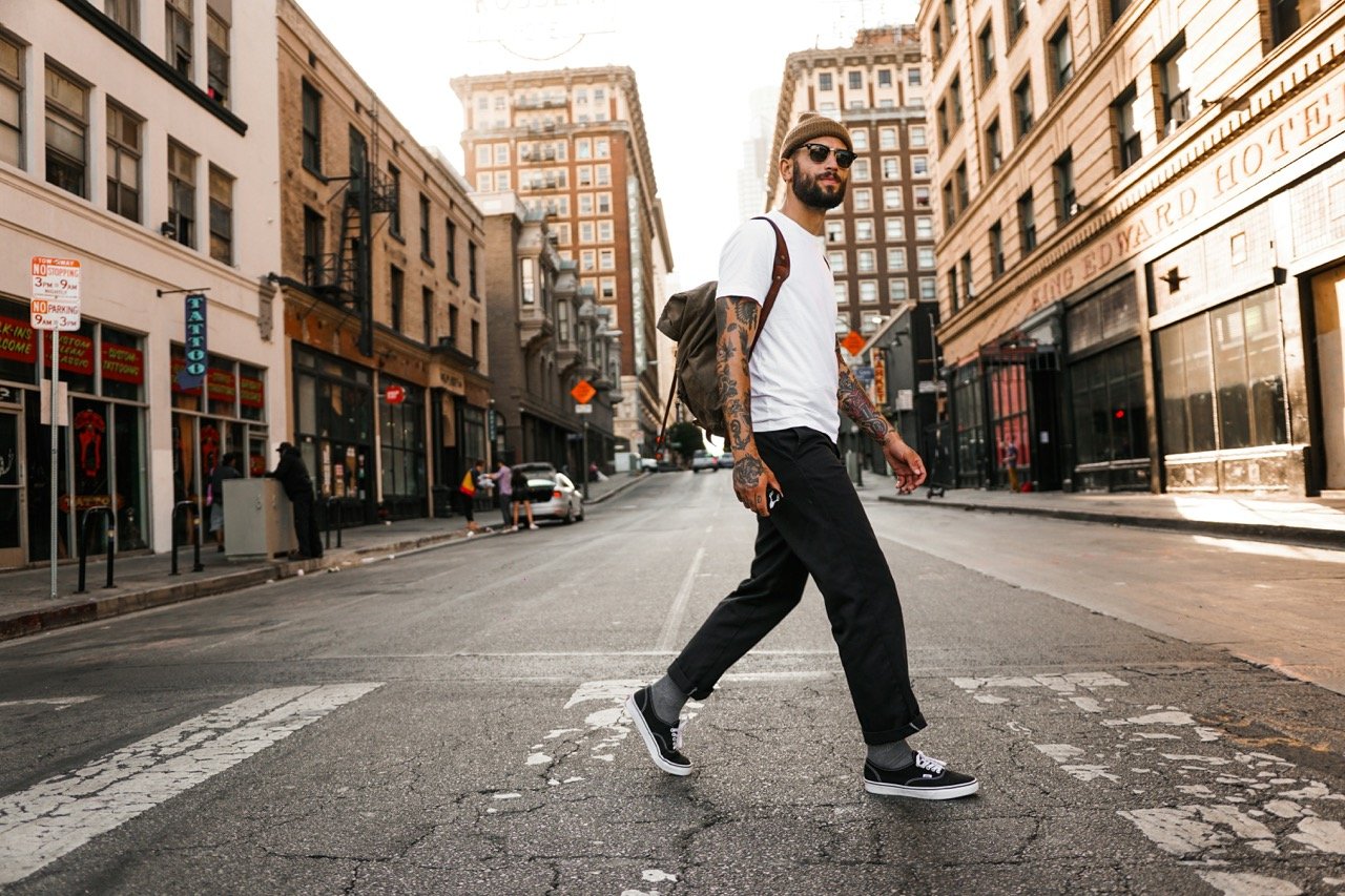 Man walking through a city street, representing the benefits of walking for daily exercise