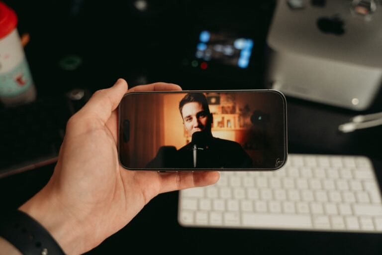 A person holds a smartphone while watching a content creator, illustrating the growing influence of parasocial relationships and online creators.