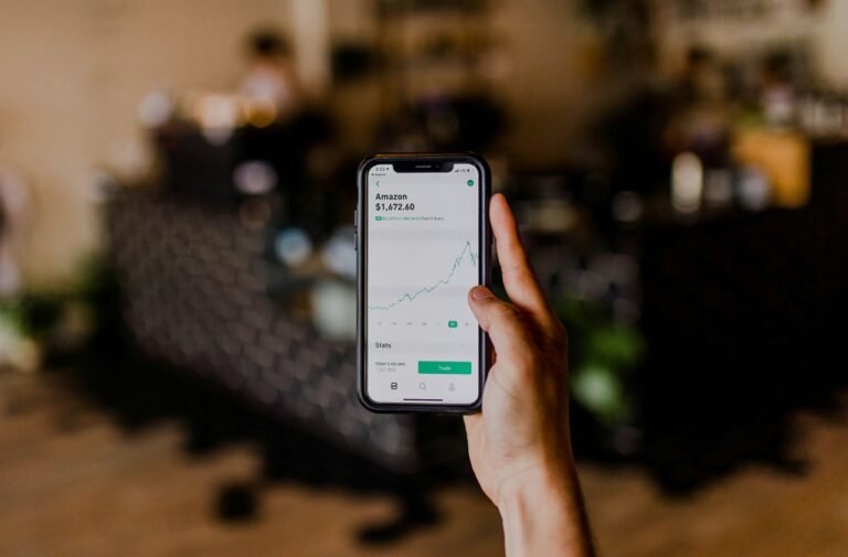 Person checking a stock market chart on a smartphone