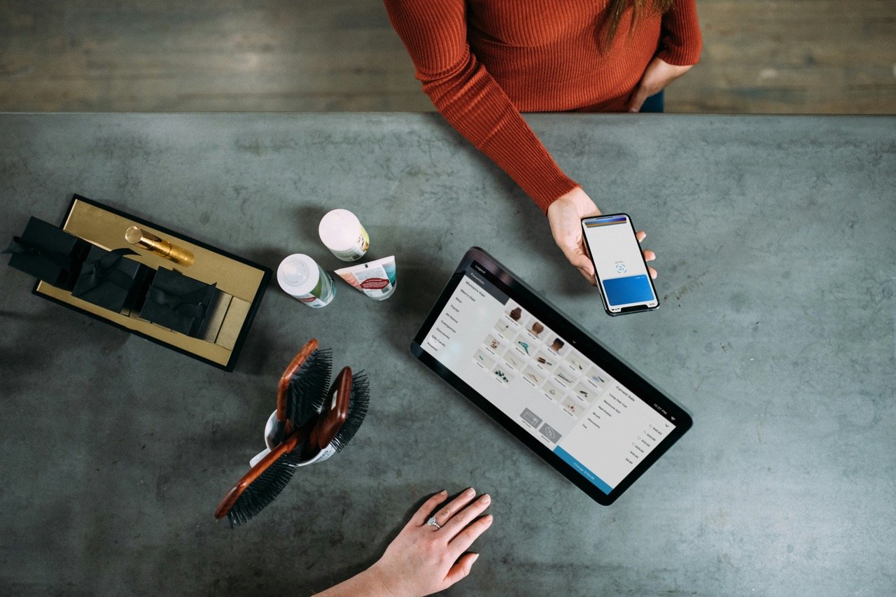 Customer paying with a smartphone at a retail checkout
