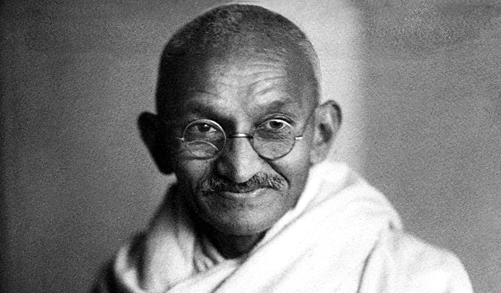 Historical black-and-white portrait of Mahatma Gandhi