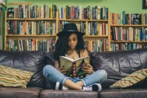 Young woman reading a book in a library
