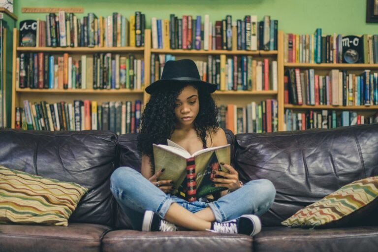 Young woman reading a book in a library