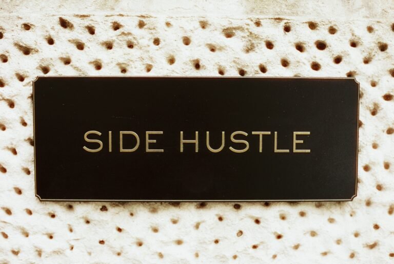 Black sign reading “Side Hustle” on a patterned background