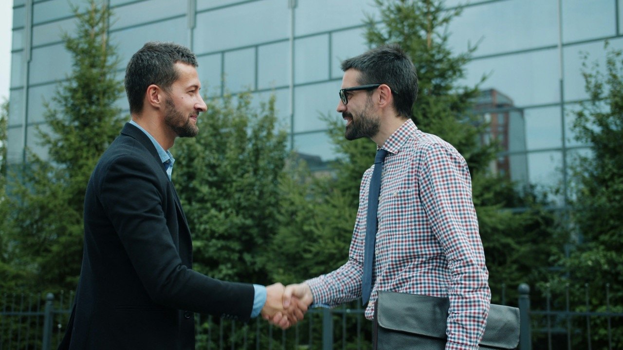 Two professionals shaking hands during a first meeting