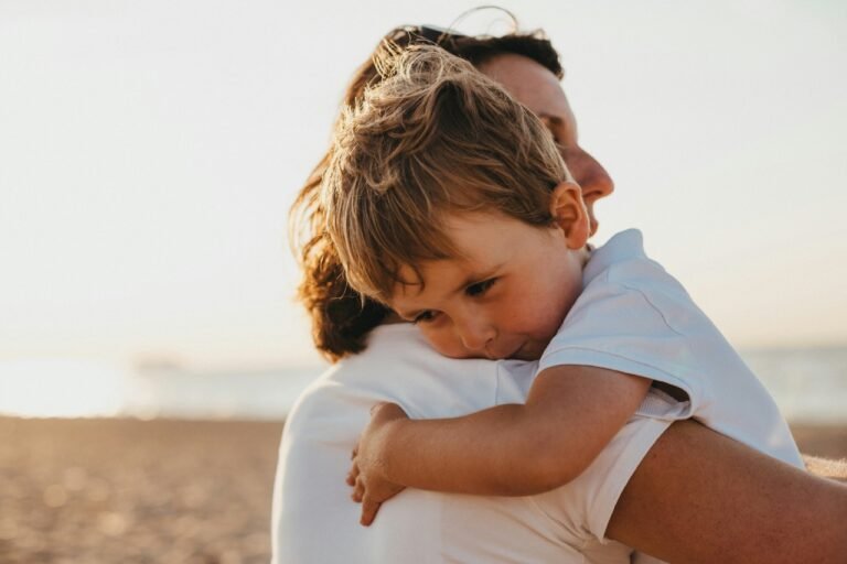 Parent holding a young child at the beach