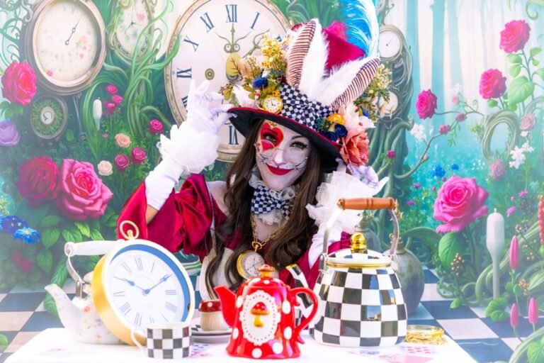 Woman dressed as a whimsical Mad Hatter with face paint and an elaborate hat, surrounded by colorful teapots, clocks, and roses.